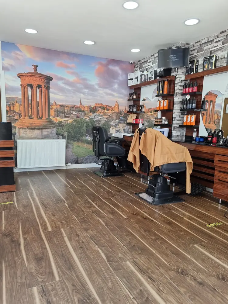 Barber shop floor with walnut flooring and a large Calton Hill Edinburgh mural on the wall